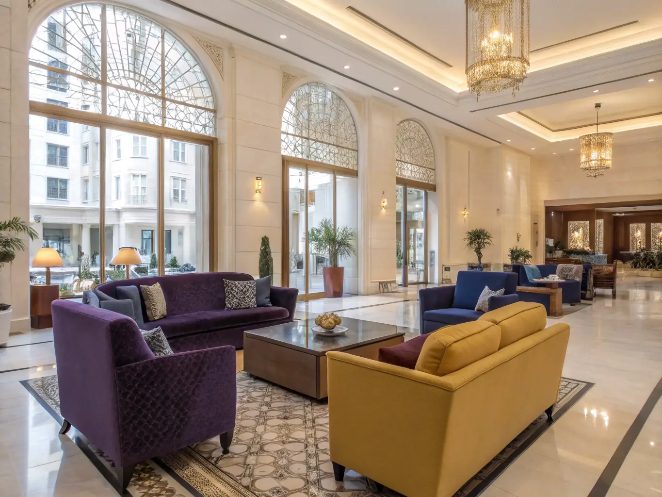 A luxurious hotel lobby featuring FYLM smart glass partitions, creating an elegant and adaptable space. The glass can switch from transparent to opaque, providing privacy for guests while maintaining an open and welcoming atmosphere.